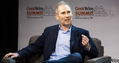 A person in a blue shirt and dark jacket is speaking while seated at the GeekWire Summit.