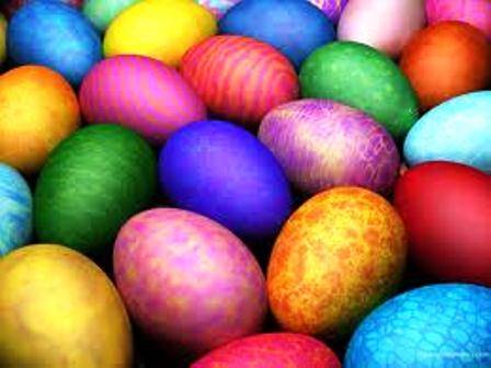 A variety of brightly colored, patterned Easter eggs are grouped together.