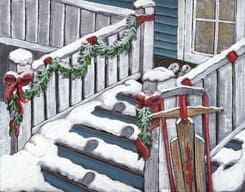 Snow-covered steps decorated with garlands and red bows lead up to a porch with a traditional wooden sled leaning against the railing.