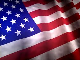 A close-up image of the United States flag showing the blue field with white stars and red and white stripes.