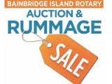 Sign for the Bainbridge Island Rotary Auction & Rummage Sale with an orange price tag.