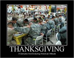 Group of soldiers in camouflage uniforms sit around a table, holding hands and bowing their heads in prayer, under the heading "THANKSGIVING" with the caption "A Genuine And Enduring American Attitude.