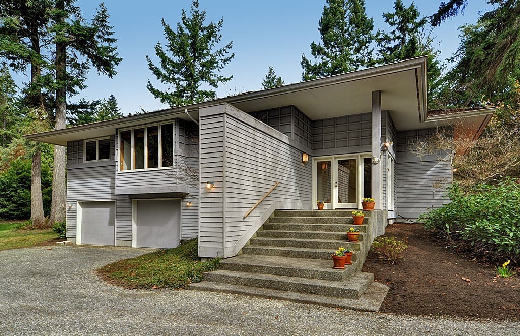 Gray house with double doors and steps.