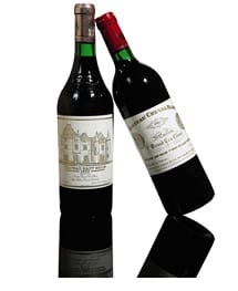 Two bottles of red wine with detailed labels. One bottle has a silver cap, and the other has a red cap. The bottles are positioned at a slight angle to each other.