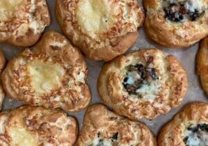 Close-up of freshly baked cheese and mushroom buns.