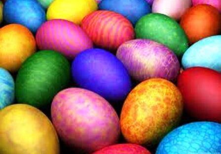 A variety of brightly colored, patterned Easter eggs are grouped together.