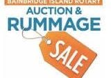 Sign for the Bainbridge Island Rotary Auction & Rummage Sale with an orange price tag.