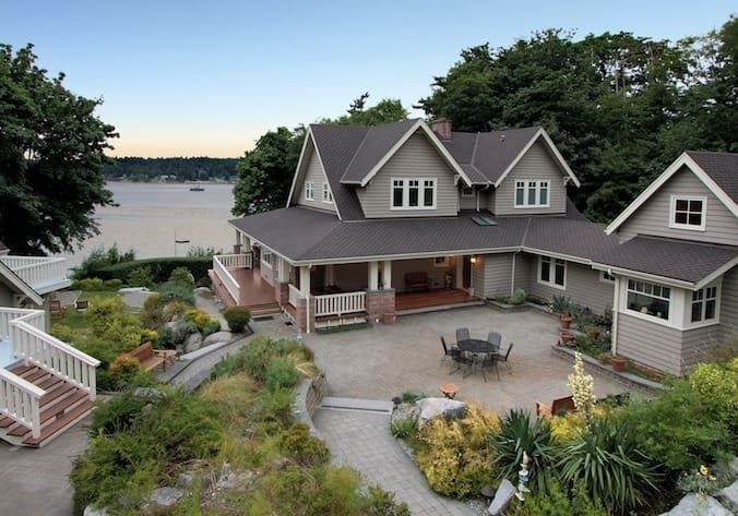 Two-story house with a porch and patio.