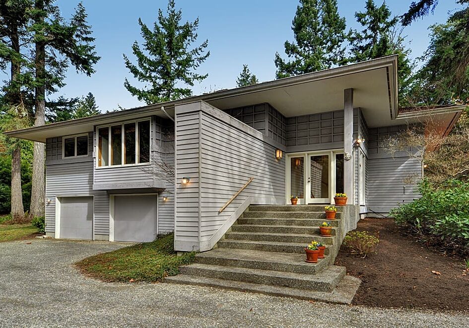 Gray house with double doors and steps.