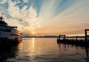 Ferry boat at sunset by the pier.